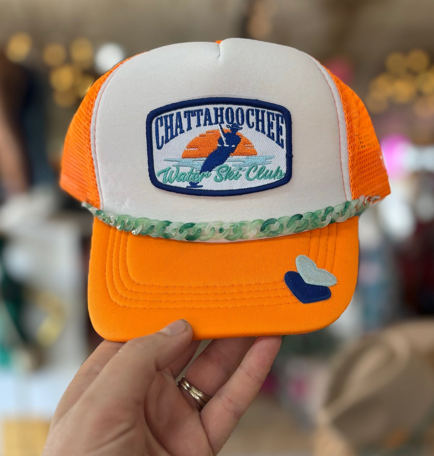 Trucker hat with a white and gold color scheme, featuring the Chattahoochie Water Ski Club logo and hat band.