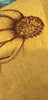 Hand burning a sunflower on a cap